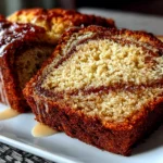 Close-up of freshly prepared cinnamon swirl banana bread on white plate